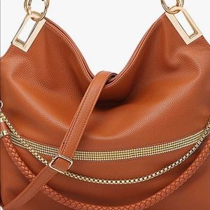 Brand New Stylish bag  that may be worn as a crossbody, shoulder or handbag.